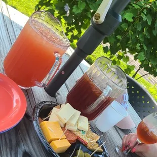 A pitcher of Pink Lemonade and a pitcher of Paper Moon Tea.
