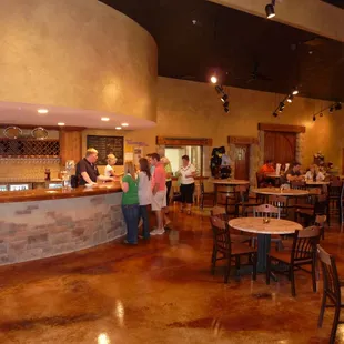 The tasting room features a large copper counter, stone/stucco decor, and a marvelous fireplace to stay warm by in the winter.