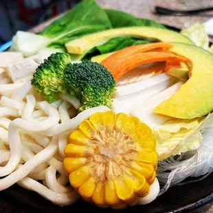 a plate of noodles and vegetables