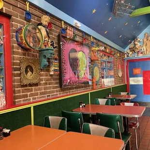 tables and chairs in a brightly decorated restaurant