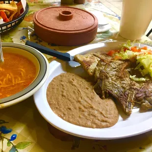 One of today's lunch special: (two) grilled pork chop plate with a bowl of fideo and tortillas