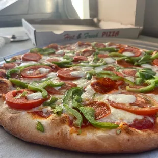 a pizza with tomatoes and peppers