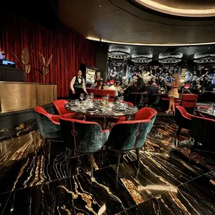 a large dining room with a table and chairs