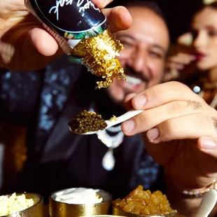 a man holding a spoon full of food