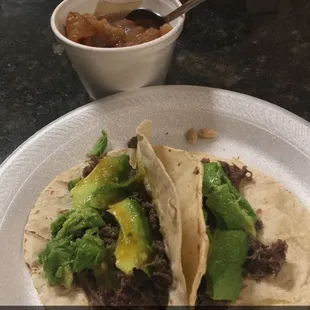 Barbacoa with avocado, fresh green salsa on a home made corn tortilla. And charro beans on the side!