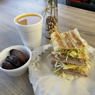 side of Sweet Plantains, cuban sandwich, and mango juice