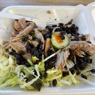 I asked for a salad not on the menu and they happily made this for me!!salad, black beans and pork with hot sauce