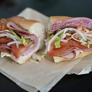 two sub sandwiches on wax paper