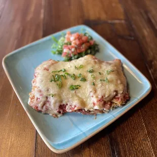 Enchiladas: 4 tortillas rolled with whipped queso spread, protein, all smothered in salsa &amp; topped with melted Chihuahua cheese!