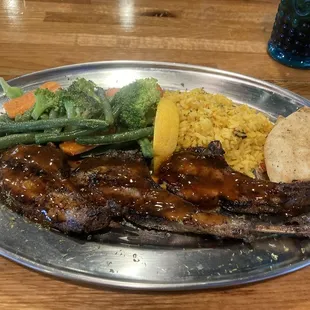 Lamb chops with Thai sauce. Very delicious and the veggies and rice were seasoned nicely. Comes with a side of pita bread.