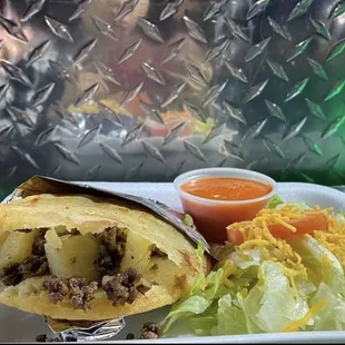 Picadillo gordita with lettuce and tomato on the side $3