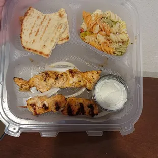 a person holding a container of food