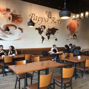 people sitting at tables in a restaurant