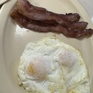 Two eggs over easy with bacon