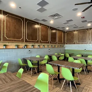 a dining area with green chairs