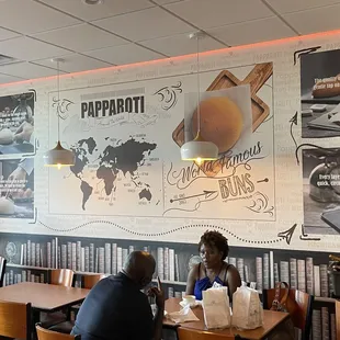 people sitting at tables in a restaurant