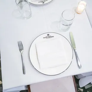 a table setting with a white table cloth