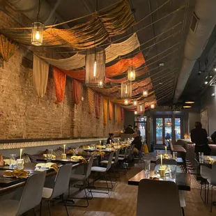 the interior of a restaurant with tables and chairs