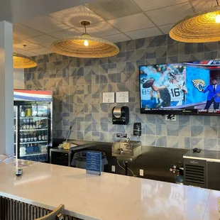 a bar with a television on the wall