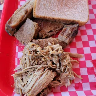 a pulled pork sandwich on a red and white checkered tray