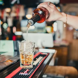 a person pouring a drink