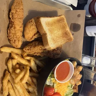 Chicken fingers , fries and salad with Texas toast.