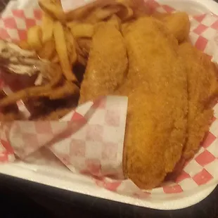 a basket of fried fish and fries