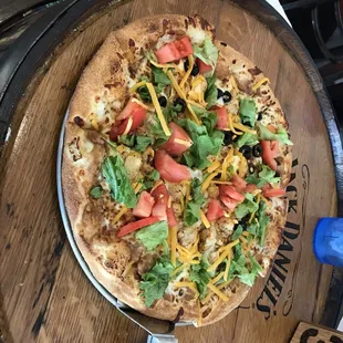 a pizza on a wooden barrel