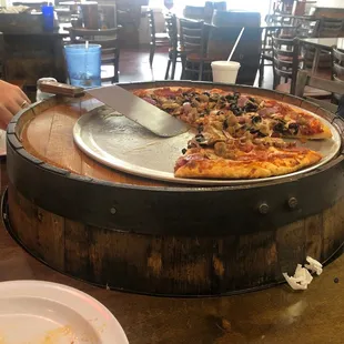 a person cutting a pizza