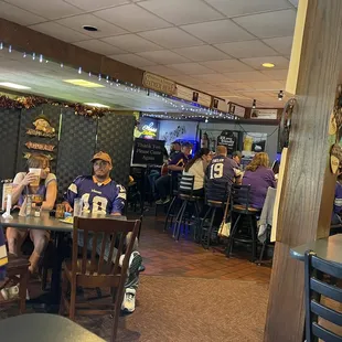 people sitting at tables in a restaurant