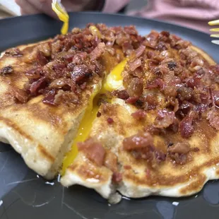 This was some sort of special pancake with a dippy egg inside with crumbled, real bacon all over the place, served with syrup!