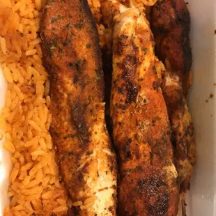 Chicken skewers over rice