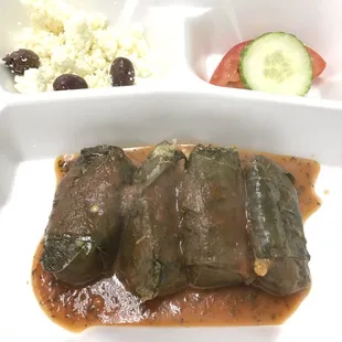 a plate of stuffed grape leaves