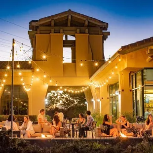 a group of people sitting around a patio