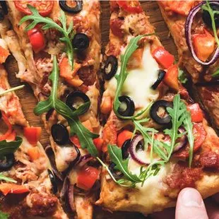 a person holding a pizza