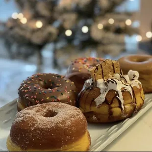 a variety of doughnuts on a tray