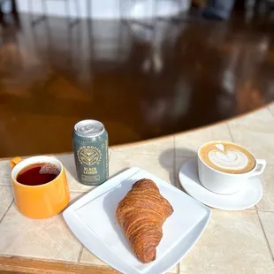 a croissant and a cup of coffee