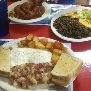 Chicken in Sauce with sides and House Specialty eggs and hash.