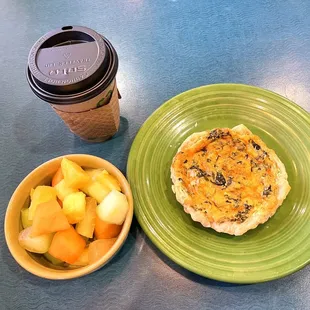 a quiche and a bowl of fruit
