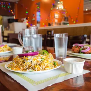 a plate of biryani pasta with onions, onions, and onions