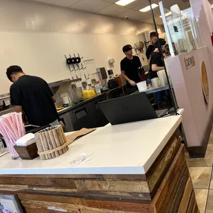 a kitchen with people in the background