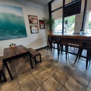 a view of a dining room with a large painting on the wall