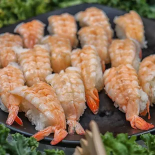 a plate of shrimp and sushi