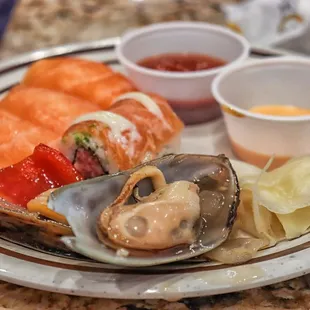 a plate of seafood and sushi