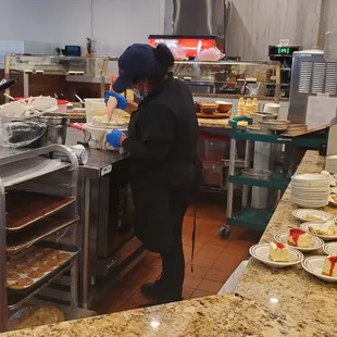 She's decorating the cake. One word - tiramisu...get it if you are a coffee lover!!