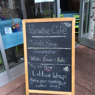 a blackboard sign outside of a restaurant