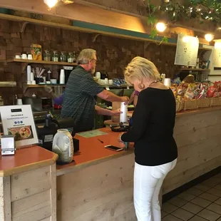 a woman ordering food at the counter