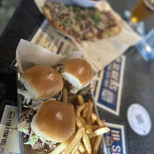 Kalua pork sliders and flatbread pizza with onion rings and fries