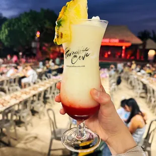 a hand holding a drink