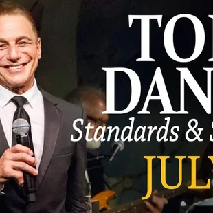 tony danza standing in front of a microphone